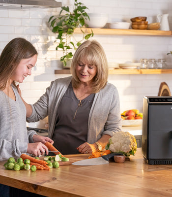 grandma and granddaughter cooking with an air fryer