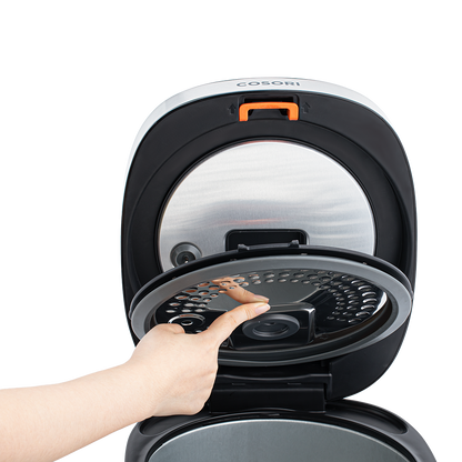 Hand demonstrating how to remove the inner lid of the Cosori Rice Cooker with a push button.