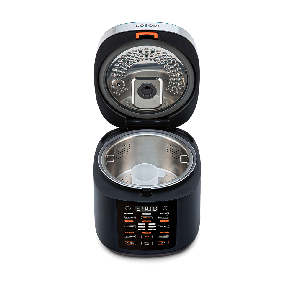 Top-down view into the open Cosori Rice Cooker showing the inner heating plate and lid structure.