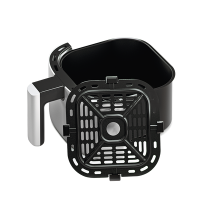 White Cosori Mini Air Fryer basket pulled out to reveal the dishwasher-safe nonstick interior.