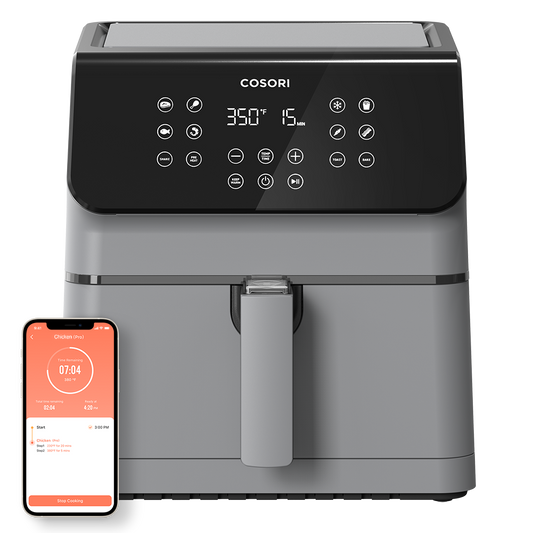 Cosori Pro II 5.8-Qt Smart Air Fryer in grey shown with a smartphone displaying the VeSync app control.