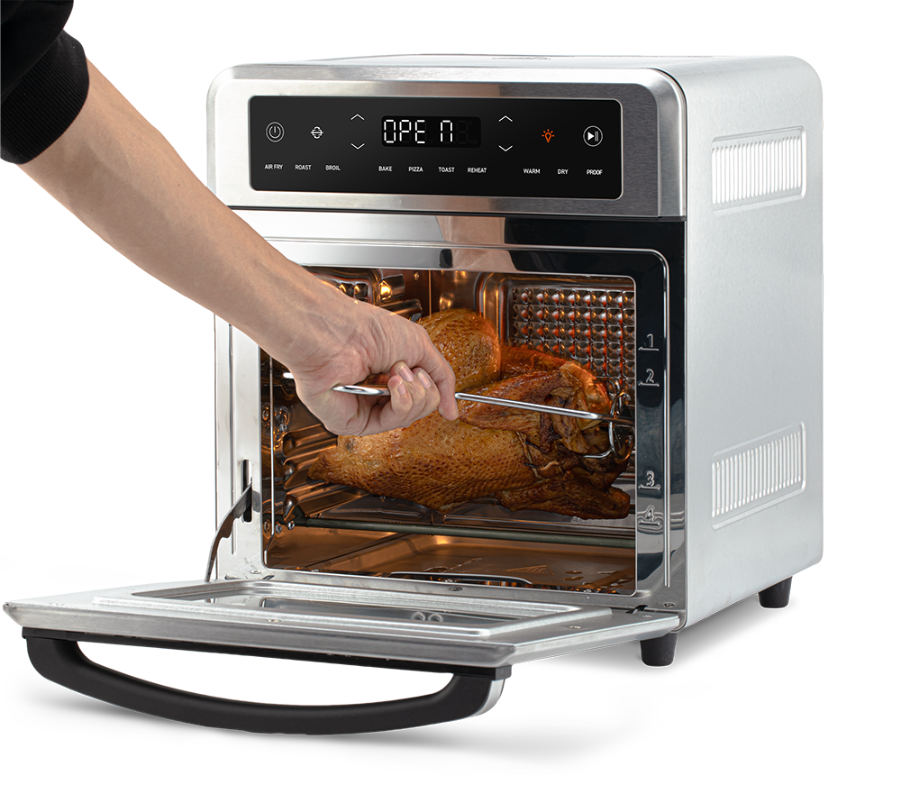 Using the fetch tool to safely remove the rotisserie spit with chicken from the Cosori Air Fryer Oven